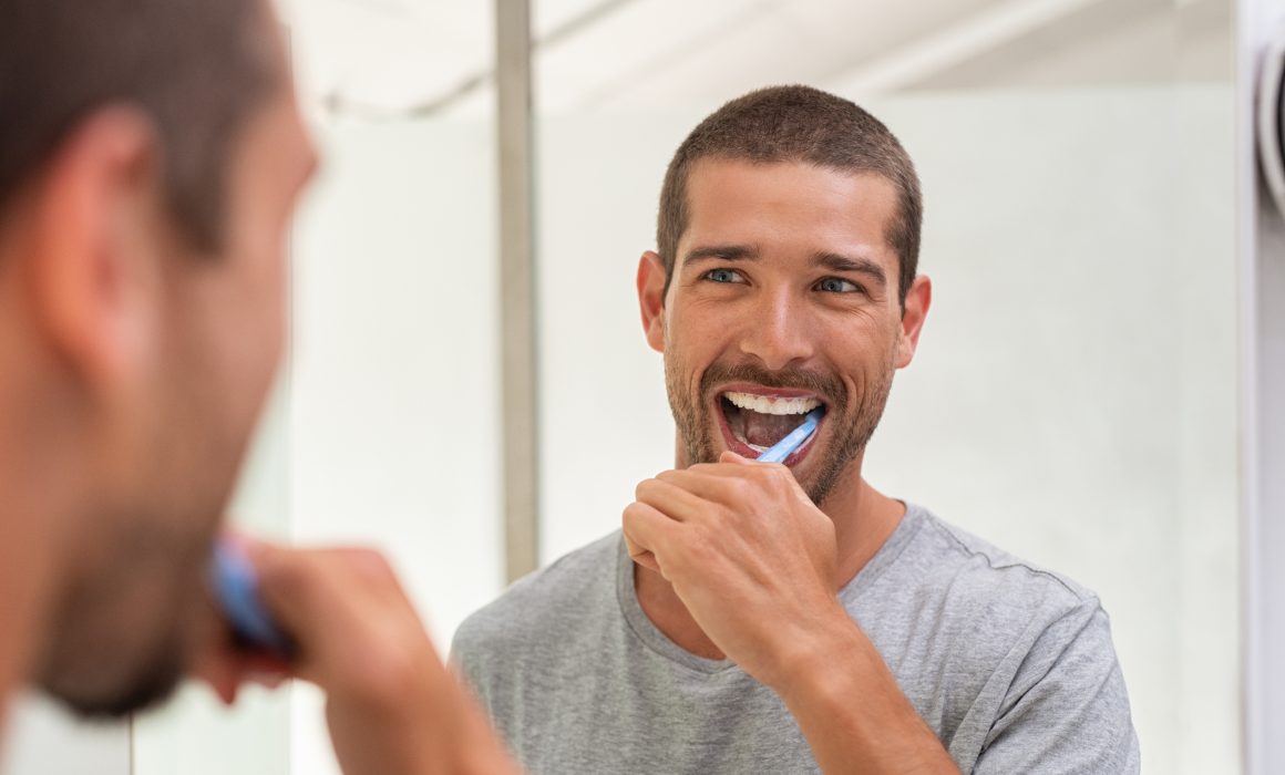 man brushing his teeth