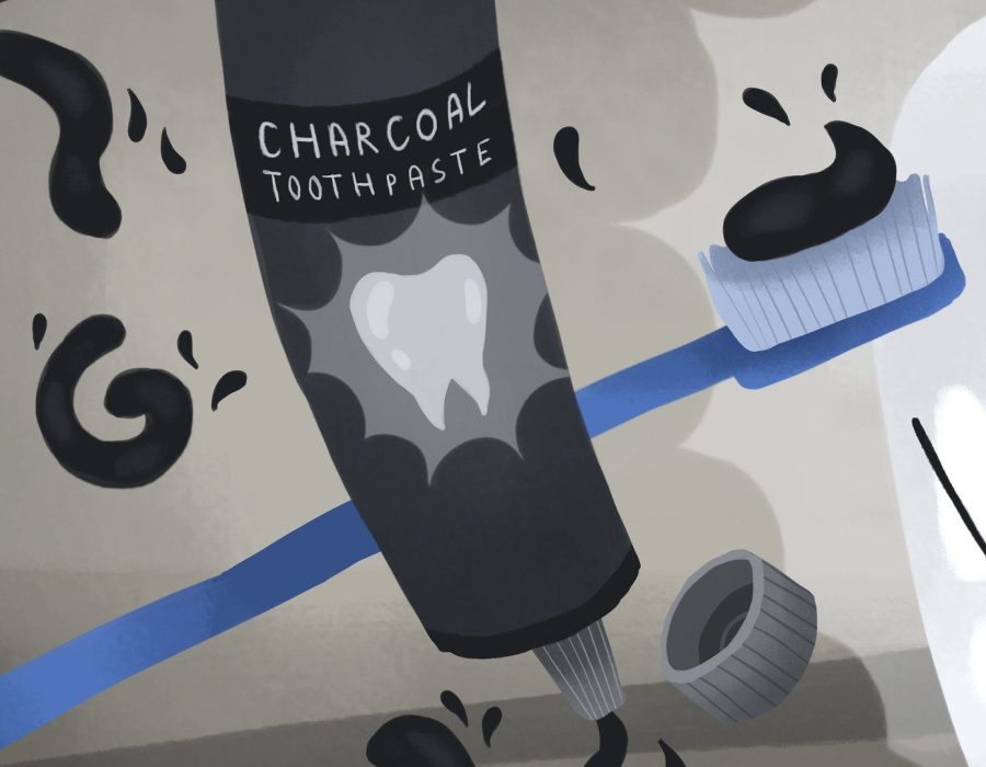 Illustration of a blue toothbrush next to a tube of charcoal toothpaste