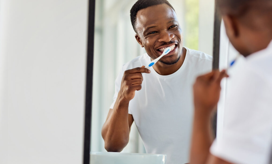 man brushing teeth for dental restoration care